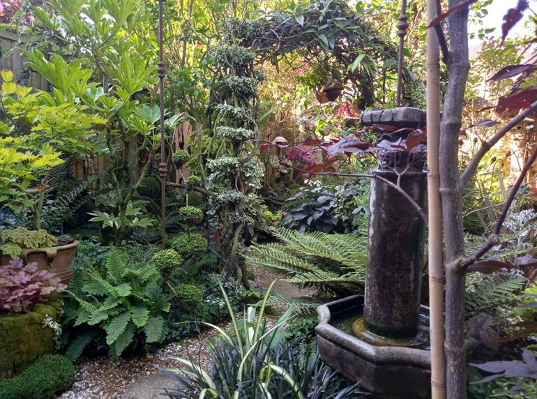 Tropical style garden with arbor